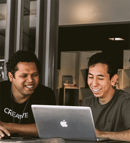 Friends Smiling at Laptop